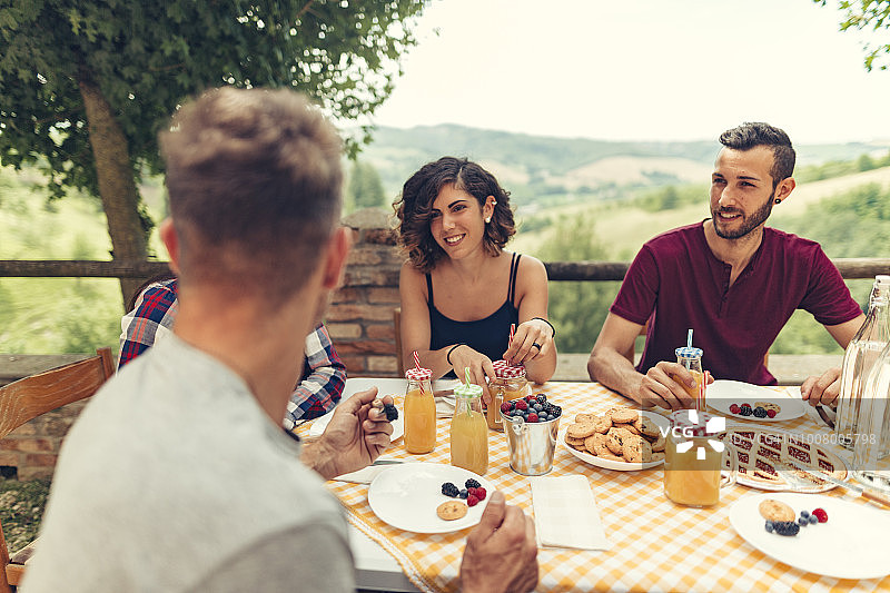 一群朋友在传统乡村户外享用早餐图片素材