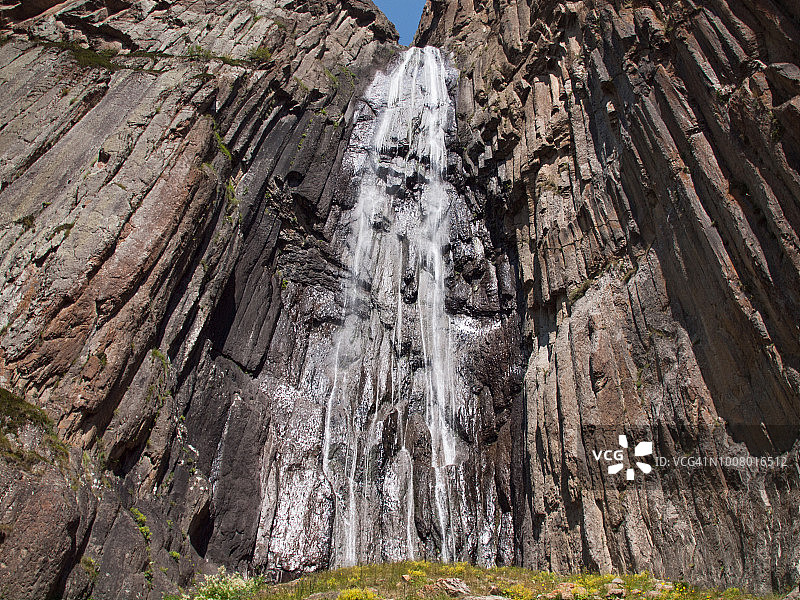 高加索山脉柱状玄武岩上的瀑布的仰视照片，俄罗斯卡巴尔达-巴尔卡尔图片素材