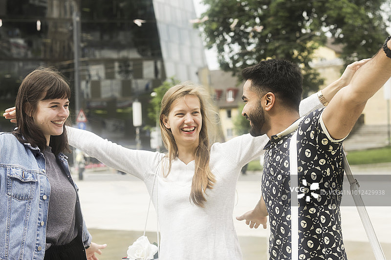 三个朋友搂着肩膀听音乐图片素材