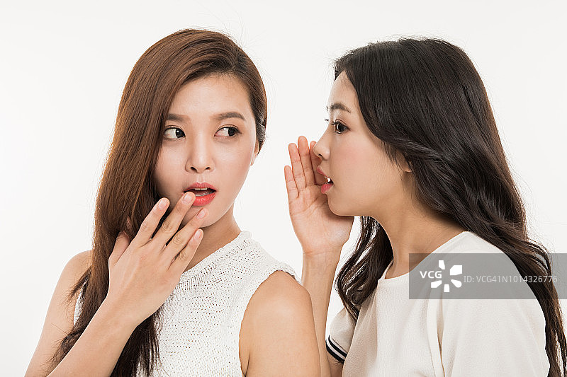 女人在朋友耳边低语图片素材