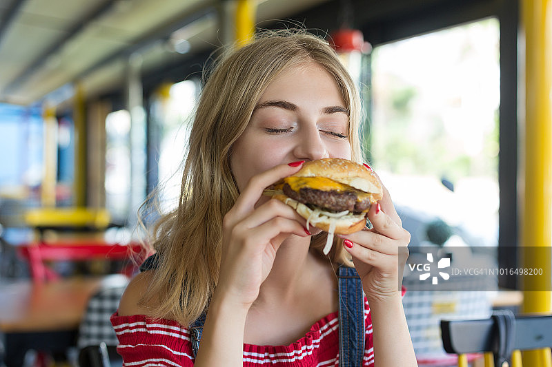 正在吃汉堡的女人图片素材