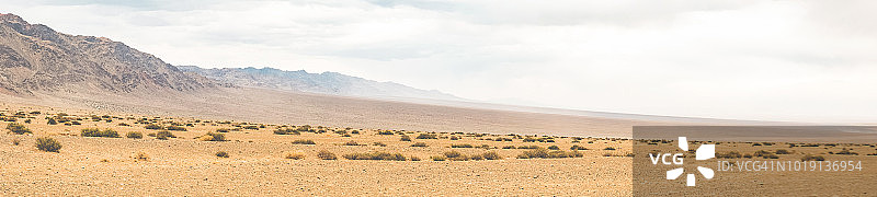 戈壁沙漠的干旱景观，山脉沿线覆盖着沙漠灌木图片素材