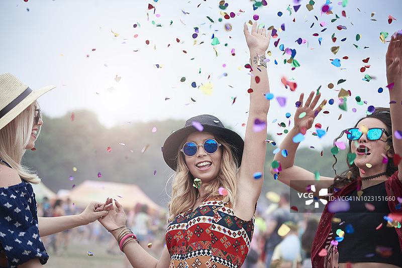 朋友们在音乐节的五彩纸屑中跳舞图片素材