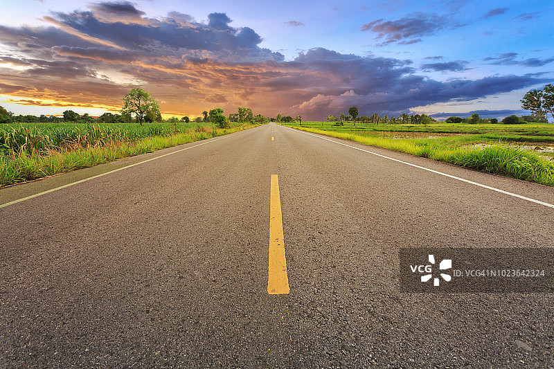 空旷的模糊沥青路面和阳光以及象征成功的标志。成功概念。图片素材