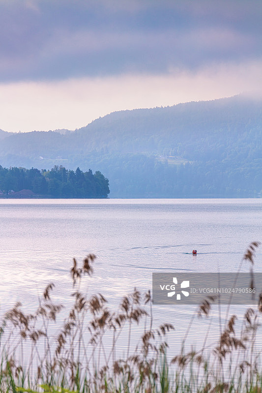 一位老人在奥地利克拉根福特韦尔特湖游泳图片素材