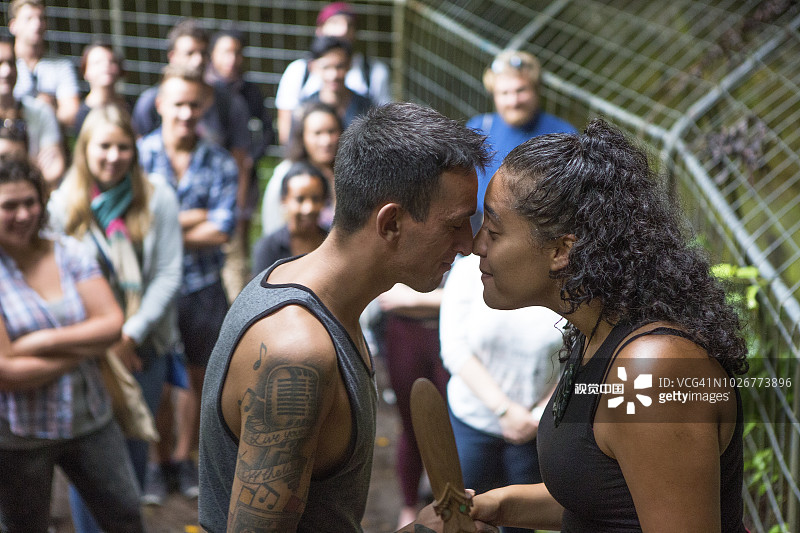 游客参观新西兰最古老的毛利岩画，当地妇女展示传统文化图片素材