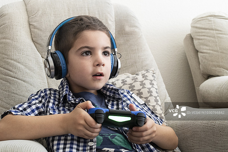 男孩玩电子游戏手柄图片素材