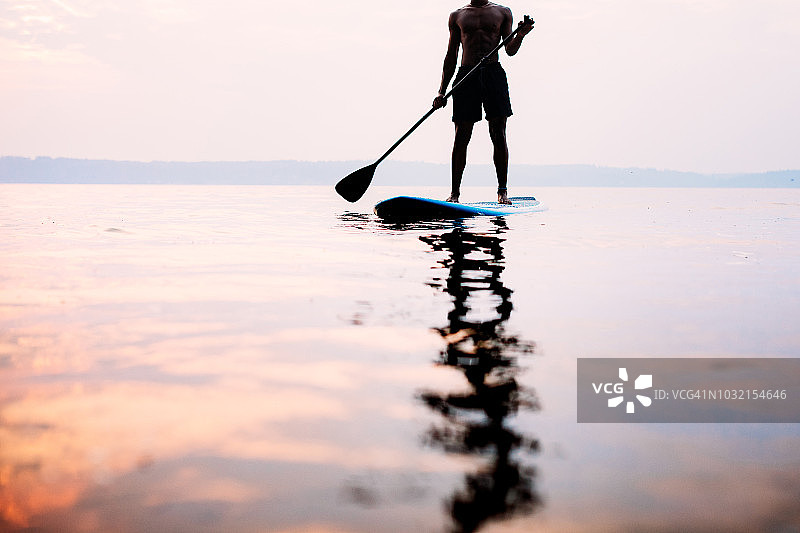 年轻男子在夏季的普吉特海湾玩桨板图片素材