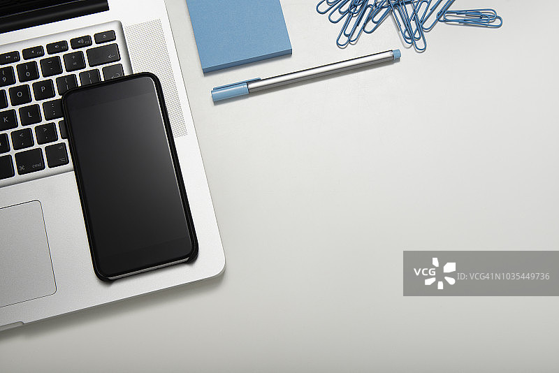 配备笔记本电脑和智能手机的桌子俯视图图片素材