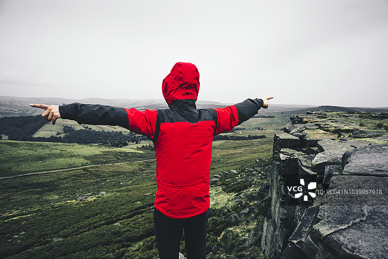 男人在岩石上张开双臂图片素材