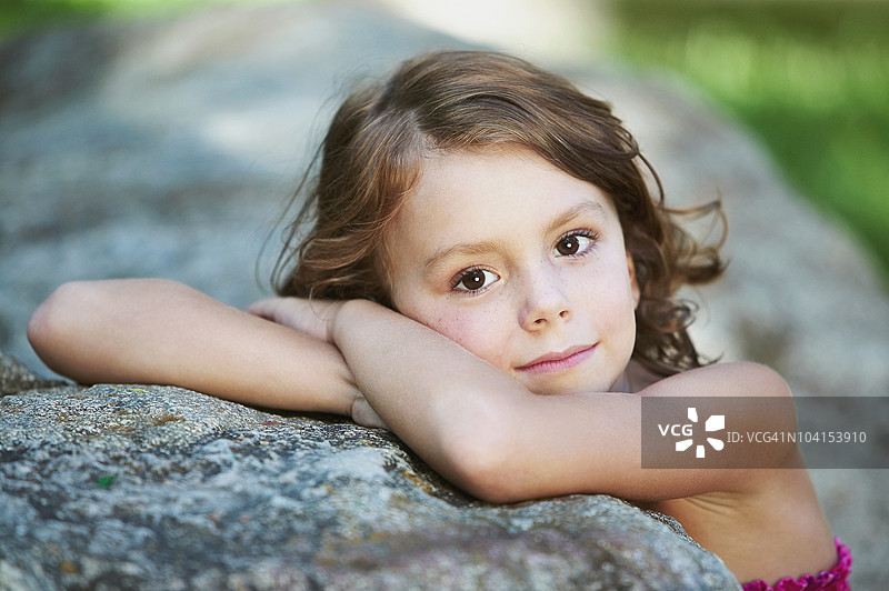 靠在岩石上的女孩肖像图片素材