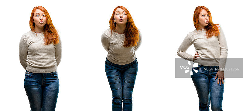 年轻漂亮的红发女人表达爱意，对着镜头飞吻，调情图片素材