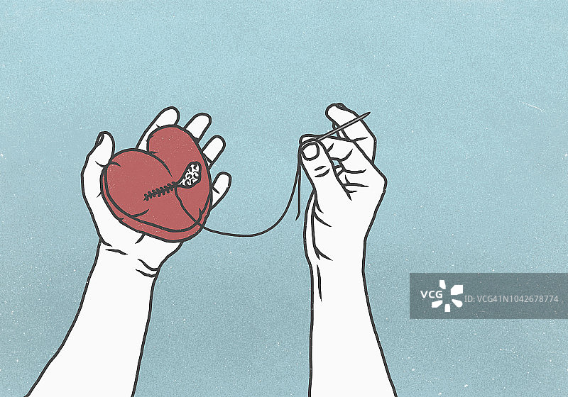 双手用针线缝补破碎的心图片素材