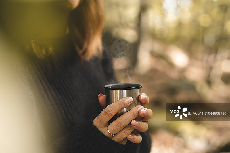女子在森林里采蘑菇并喝咖啡图片素材