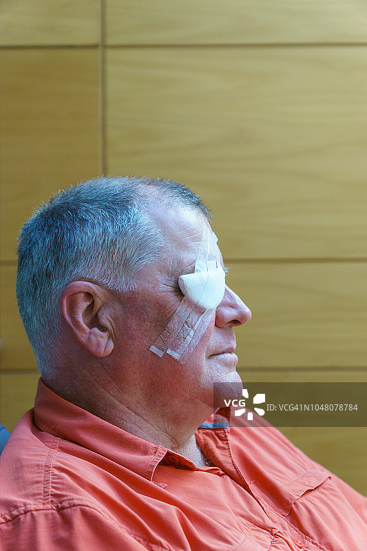 眼睛受伤后接受手术的眼睛缠着绷带的男人，导致部分视网膜脱落图片素材