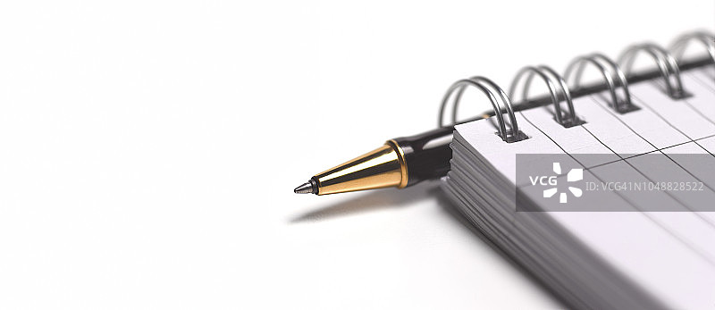 商人放在笔记本上的笔图片素材