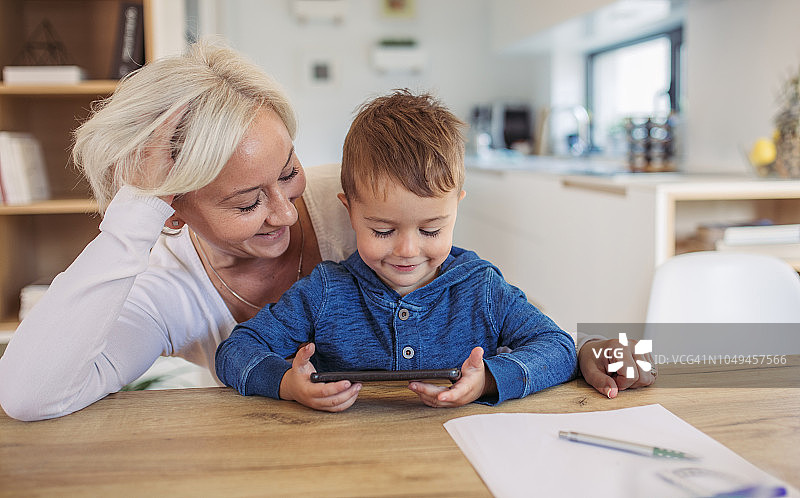 妈妈和儿子使用智能手机图片素材