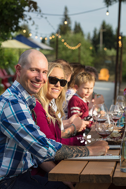 在品酒会上与父母和孩子一起微笑的夫妇图片素材