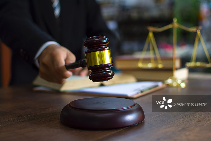 与律师在一起的法官 gavel，西装革履的商人或律师正在处理文件。法律、建议和公正概念图片素材