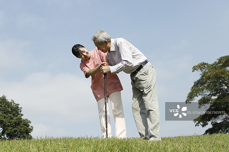 护士帮助病人拄着拐杖走路图片素材