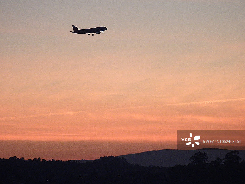 在日出时分，商业飞机进行机场进场操作图片素材