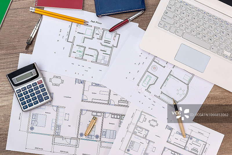 带有笔记本电脑、计算器和铅笔的房屋平面图俯视图图片素材