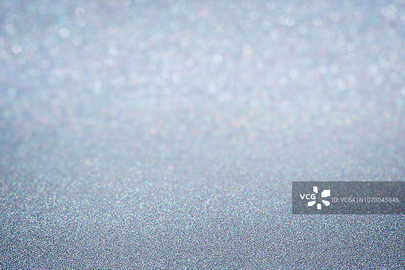 银色闪光全画幅抽象背景，具有渐晕和浅景深效果图片素材