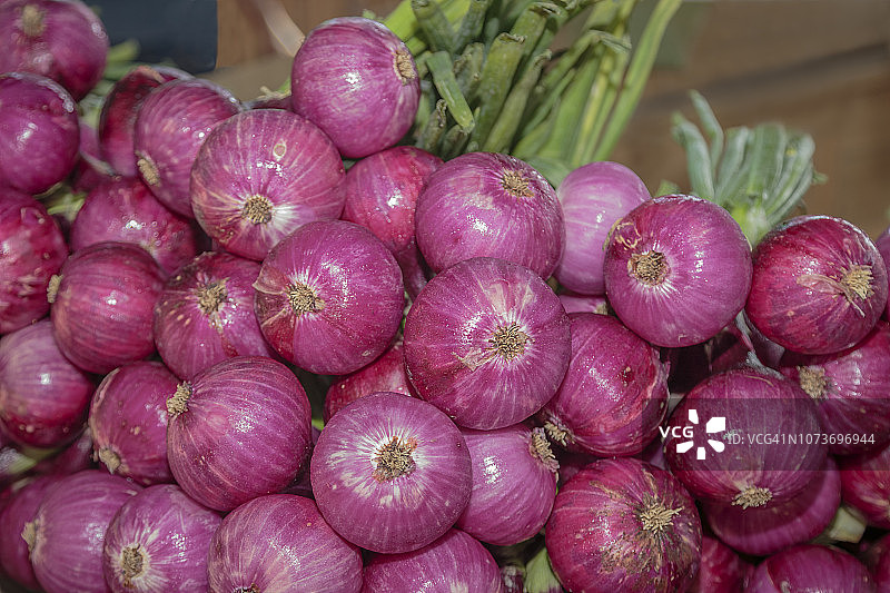 农贸市场待售的成串红洋葱图片素材