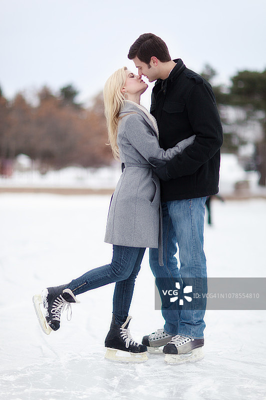 快乐浪漫的情侣在冬季滑冰图片素材