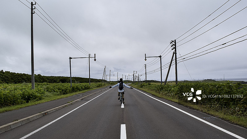 男子骑自行车旅行的背影图片素材