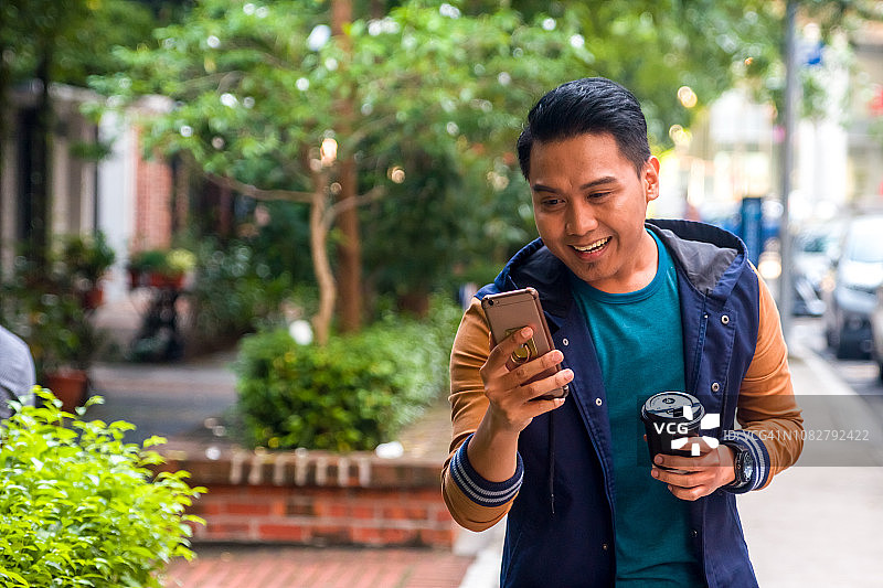 阅读手机内容后，表情惊讶的年轻男人图片素材