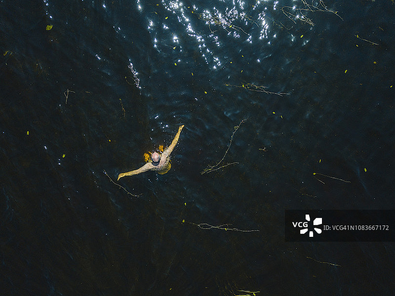 航拍：夏季爱尔兰罗斯康芒湖中游泳的男子图片素材