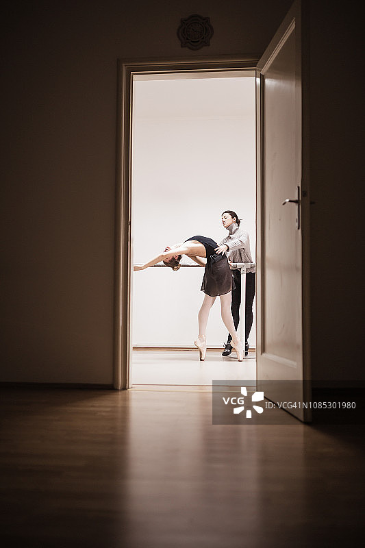 在芭蕾舞工作室与教练一起练习的芭蕾舞女图片素材