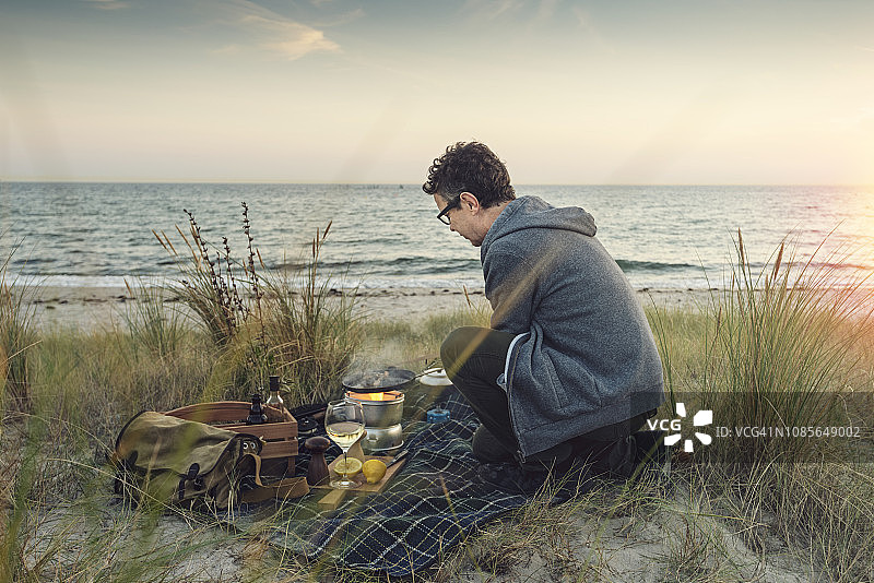 渔民在海滩上烹饪渔获图片素材