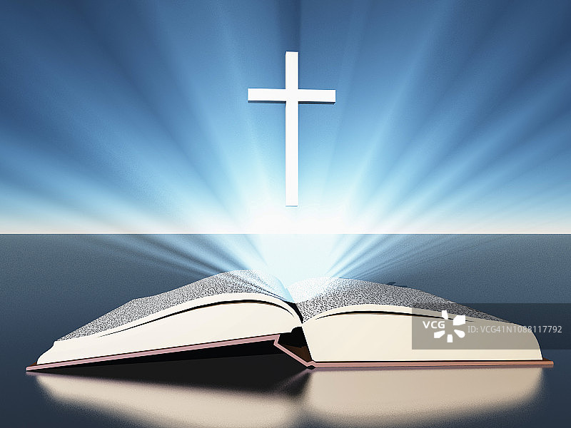 光线从十字架下的圣经中散发出来图片素材