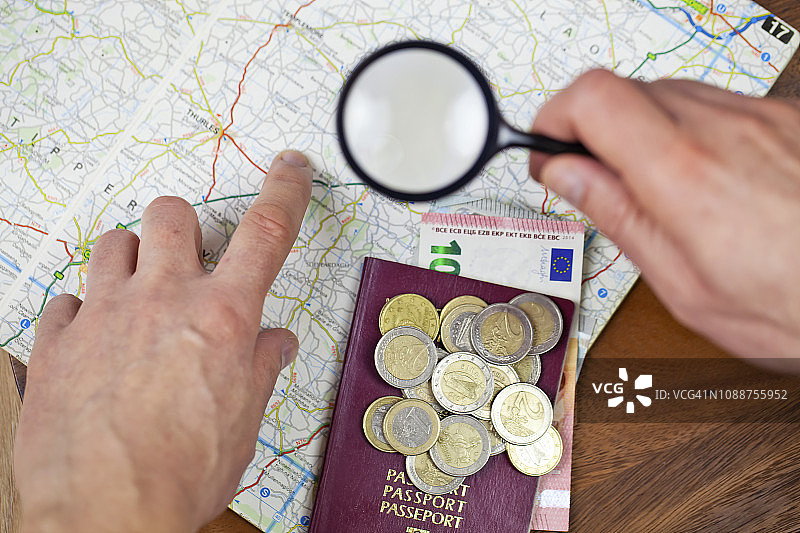 手持放大镜观察地图，旅行概念图片素材