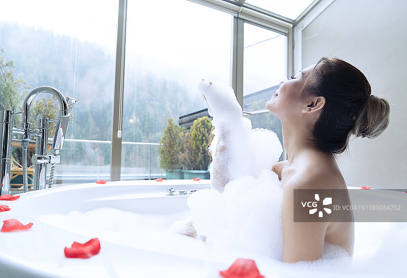 女人在热水浴缸里淋浴 - 豪华五星级酒店概念图片素材