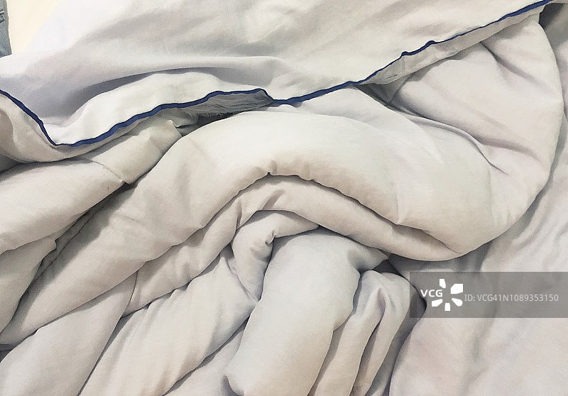 早上使用过的床、毯子和枕头图片素材