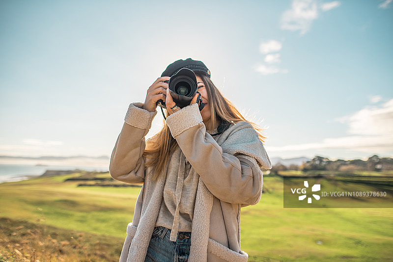年轻女人使用单反相机图片素材