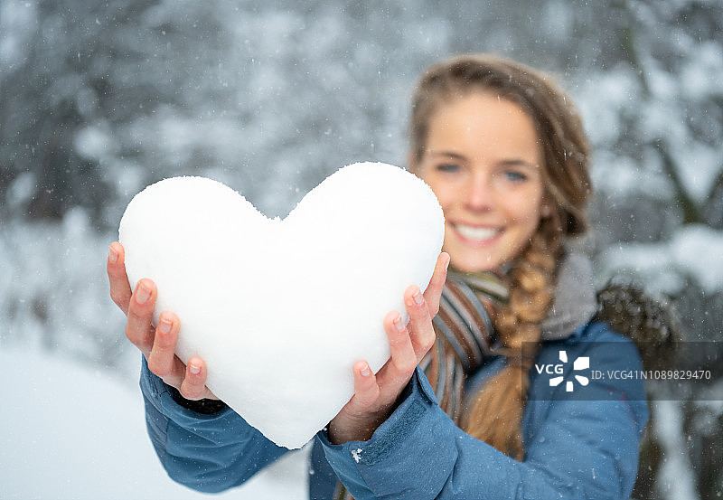 女人冬季手持雪心图片素材