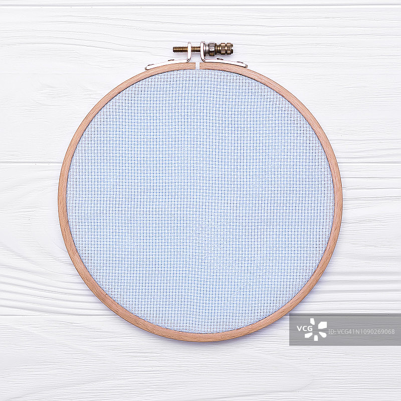十字绣工具。白色木制背景上的刺绣和帆布的箍。关于爱好的模型图片素材