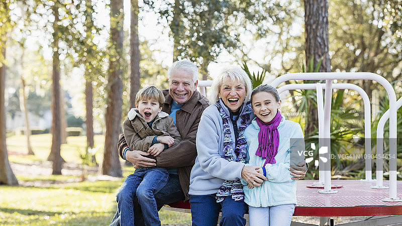 秋天在操场和祖父母玩耍的孩子们图片素材