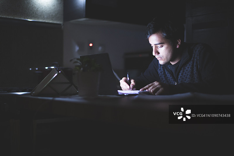 在厨房工作到深夜时准备笔记图片素材