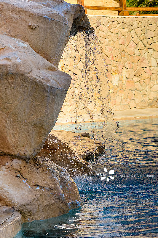 酒店泳池中碧绿水色的小瀑布图片素材