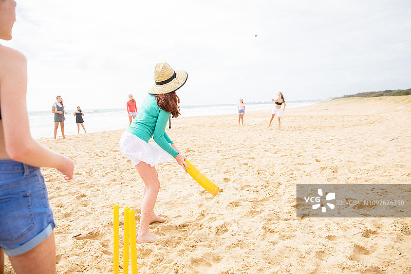 在澳大利亚海滩上玩耍、奔跑和交谈的青少年朋友图片素材