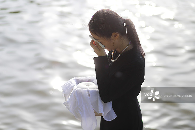 手捧骨灰盒悲伤的女人图片素材