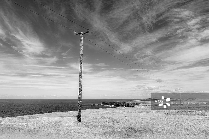 爱尔兰海岸线旁的电力线路图片素材