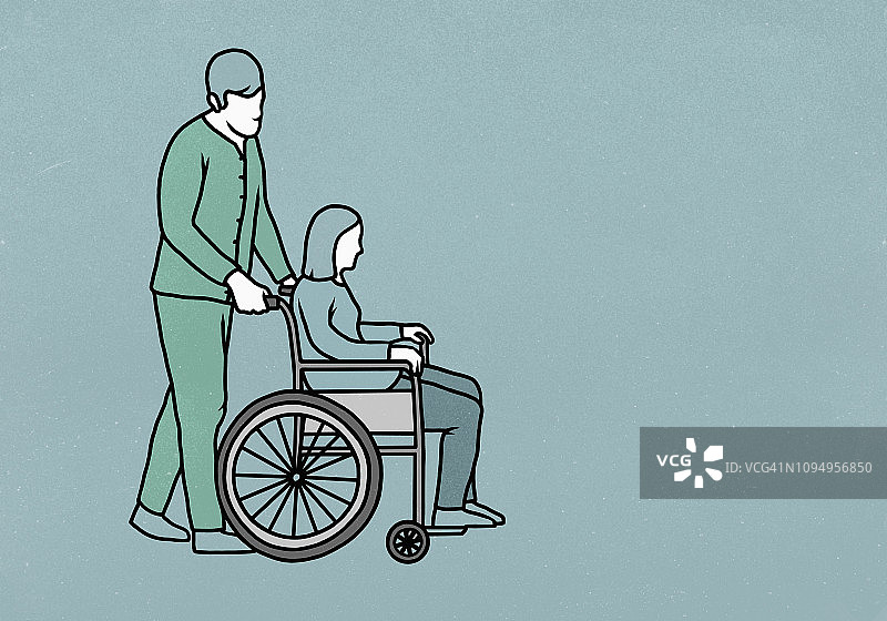 男护士推着坐轮椅的女人图片素材