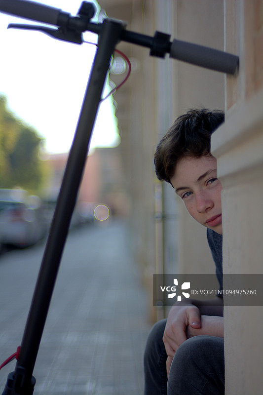 骑电动滑板车的少年肖像图片素材