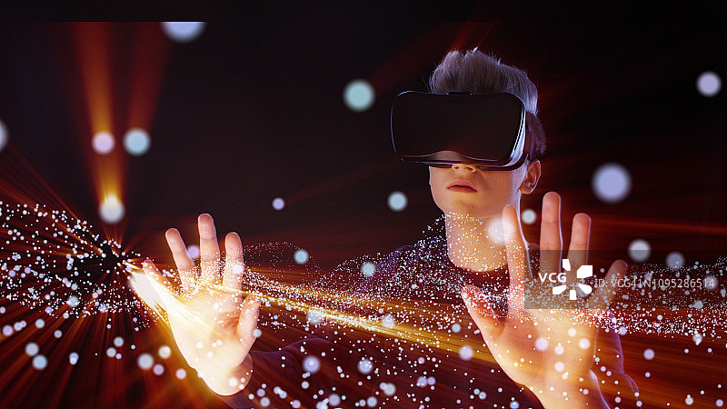 男子探索虚拟现实：VR头显和宇宙尘埃图片素材